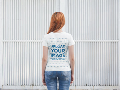 Back Shot T-Shirt Mockup of a Woman Facing a White Metal Door