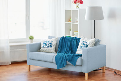 Mockup of Two Squared Pillows Placed over a Couch in a Minimalist Living Room