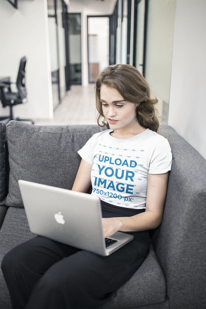 Woman Working on a Laptop Wearing a T-Shirt Mockup at the Office