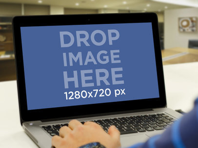 Mockup of a Man Working on His Laptop at the Office