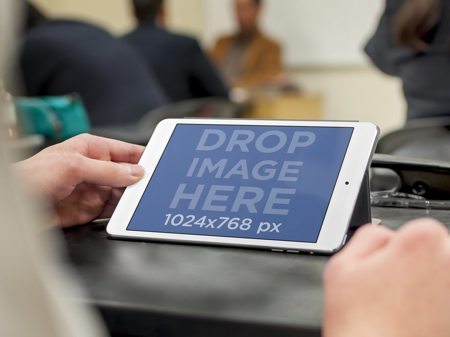 Mockup of Someone Using an iPad in a Classroom