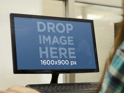 Desktop PC Mockup Featuring a Woman Doing Work