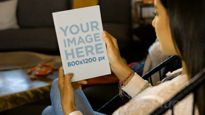 Video Of A Woman Holding A Flyer On Her Hands While Sitting On An Acapulco Chair Mockup