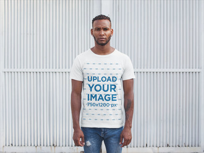 Front Shot T-Shirt Mockup Featuring a Man Against a White Metal Door