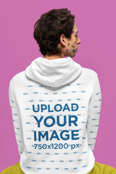 Back-View Hoodie Mockup Featuring a Man With Stickers on His Face