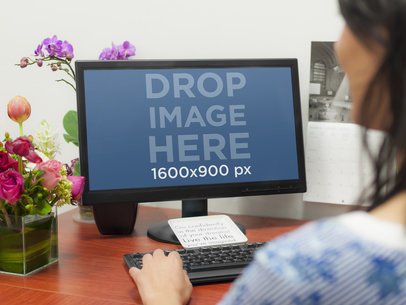 Desktop PC Mockup Featuring a Woman at Her Desk