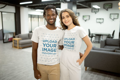 Smiling Interracial Couple Wearing T-Shirts Mockup at the Office