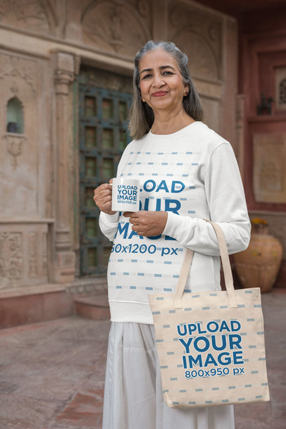 11 oz Coffee Mug Mockup of an Elderly Woman in a Sweatshirt Carrying a Tote Bag