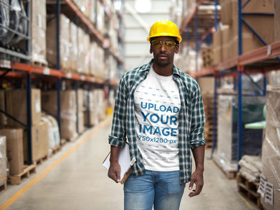 Man Wearing a T-Shirt Mockup and a Plaid Shirt at the Warehouse