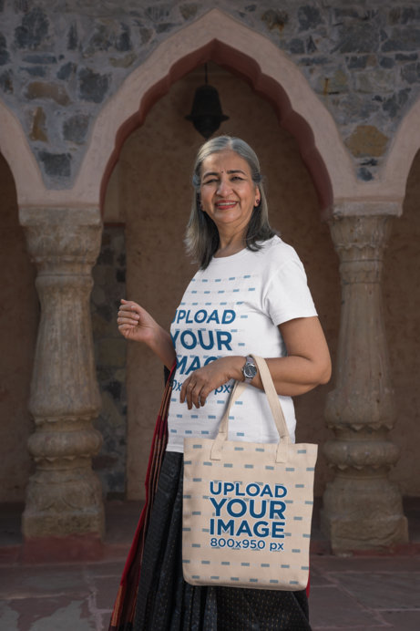 Tote Bag Mockup Featuring a Cheerful Woman at an Ancient Temple