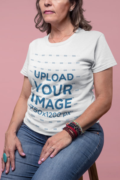Closeup Shot of a Senior Lady Wearing a T-Shirt Mockup Sitting on a Stool a20371