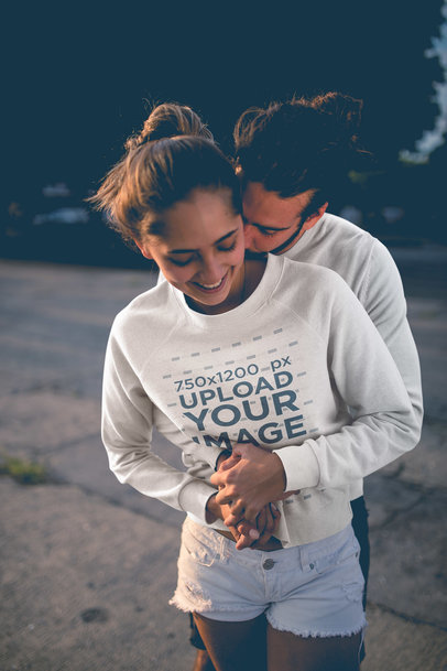 Happy Woman Wearing a Crewneck Sweater Mockup Being Hugged by her Boyfriend a20595