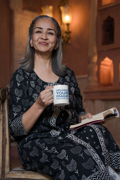 Mockup of a Senior Woman Holding an 11 oz Coffee Mug and a Book