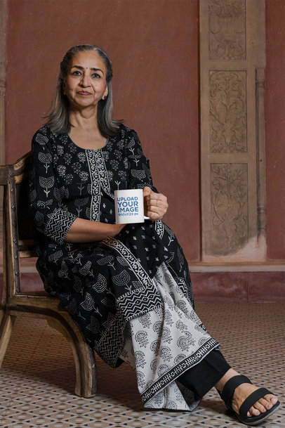 11 oz Coffee Mug Mockup Featuring a Senior Woman Sitting on a Chair