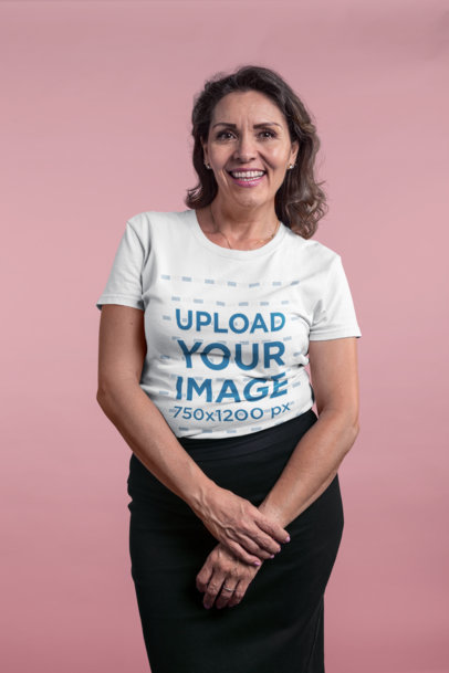 Smiling Elder Lady Wearing a T-Shirt Mockup in a Pink Room a20373