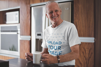 Smiling Senior Man Having a Cup of Coffee Wearing a T-Shirt Mockup