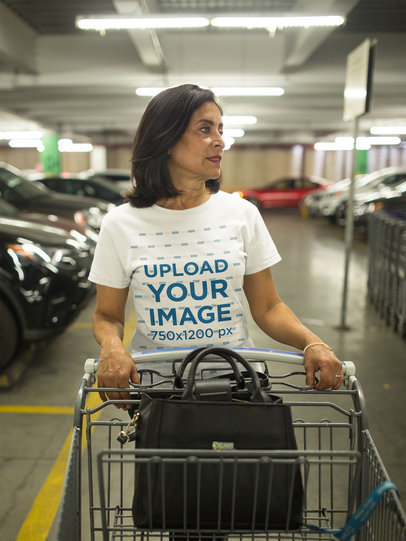 Senior Woman Wearing a Tshirt Mockup Looking for her Car in the Parking Lot