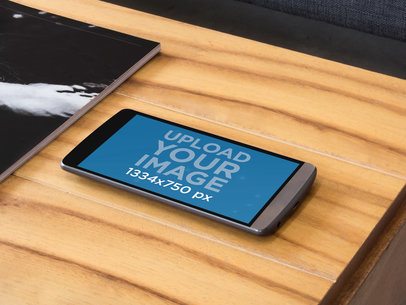 Mockup of an LG Phone on a Wooden Table