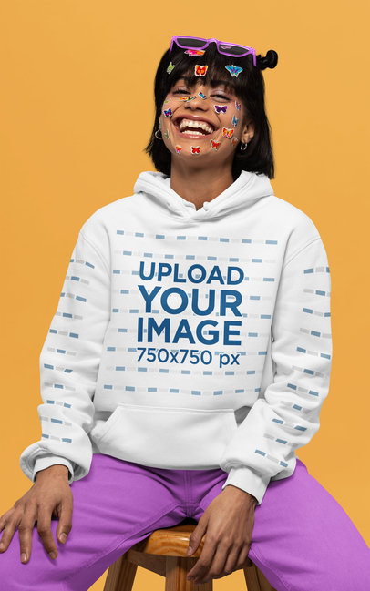 Pullover Hoodie Mockup of a Joyful Woman Wearing Butterfly Face Stickers