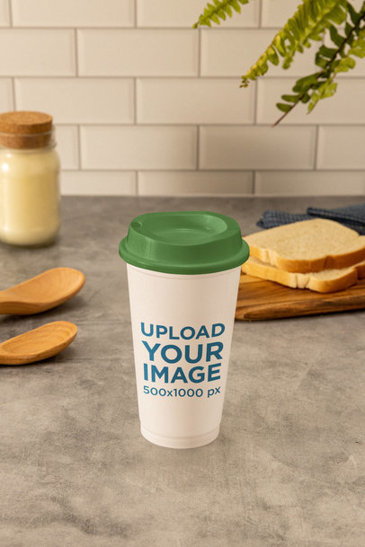 Mockup of a Paper Coffee Cup Placed on a Kitchen's Table