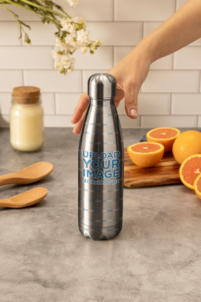 Mockup of an Aluminum Bottle Placed by Sliced Oranges