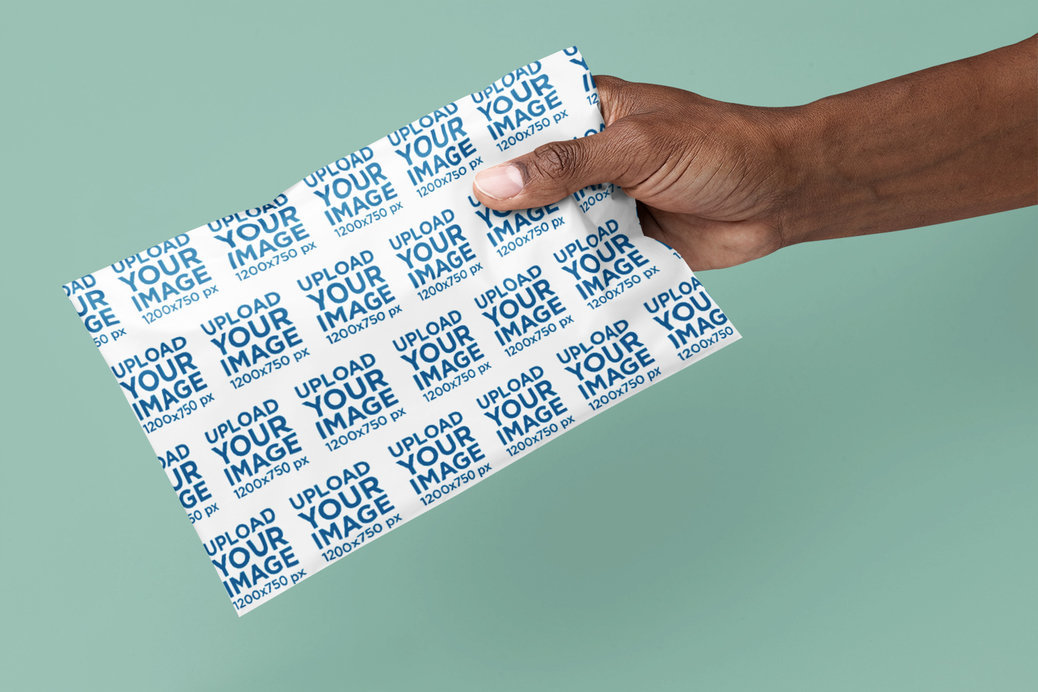 Placeit - Mockup of a Person Holding a Poly Mailer