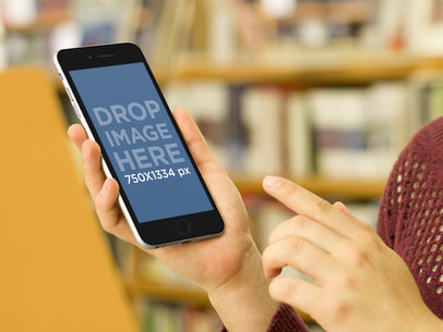 Mockup of a Woman Pointing at an iPhone 6
