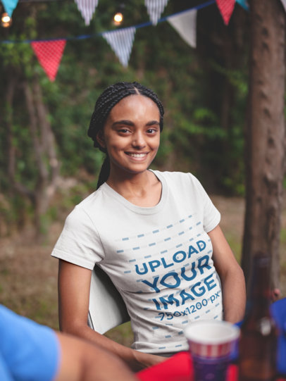 Young Woman with Braids Wearing a T-shirt Mockup at a 4th of July BBQ Party