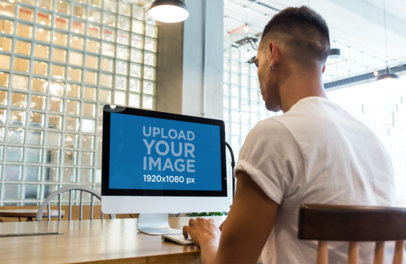 iMac Mockup Being Used by a Man at a Startup a20751