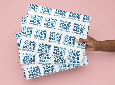 Mockup of a Person Holding Three Bubble Mailers