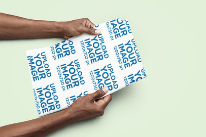 Mockup of a Person Holding a Piece of Wrapping Paper
