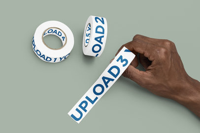 Mockup of a Man Placing Branding Tape over a Solid Surface