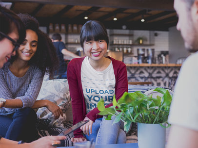 Smiling Asian Woman Wearing a Tshirt Mockup at a Meeting
