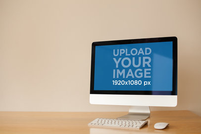 Angled iMac Mockup Standing on a Wooden Desk