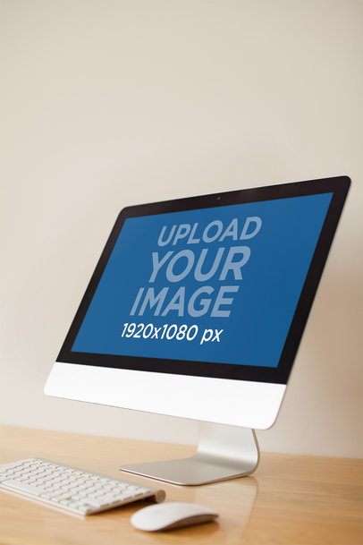 Angled Monitor iMac Mockup Standing on a Wooden Desk