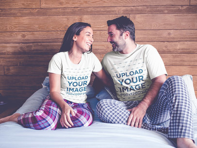 Couple Wearing T-Shirts Mockup Sitting on Their Bed