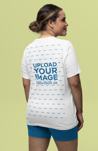 Back-View Mockup of a Smiling Woman Wearing a Bella Canvas Tee in a Studio
