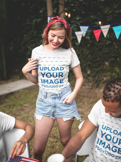 Smiling Blonde Woman and her Friend Wearing a Tshirt Mockup at a 4th of July BBQ Party