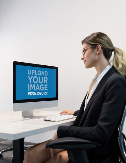 Woman Working with an iMac Mockup at the Office