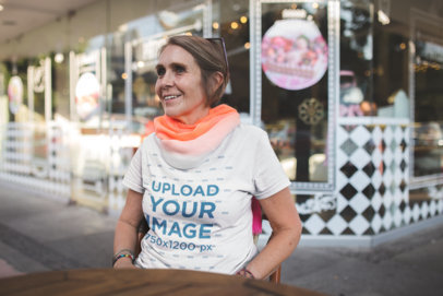 Smiling Elder Woman Wearing a Tshirt Mockup at a Coffee Shop a20672