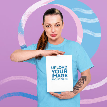 Mockup of a Tattooed Non-Binary Model Holding a Vertical Flyer m33092 r-el2