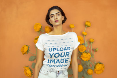 Round-Neck T-Shirt Mockup of an AI Female Posing Against Orange Flowers