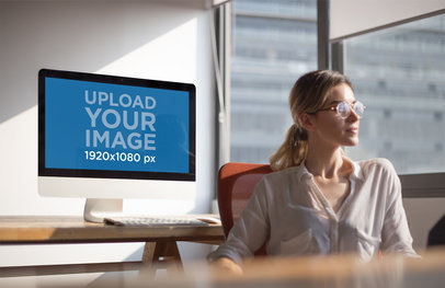 iMac Mockup Standing Near a Woman at an Office