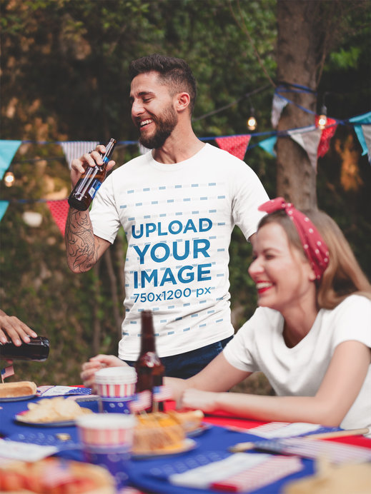 Tattooed Man Wearing a Tshirt Mockup Drinking a Beer at a 4th of July BBQ Party