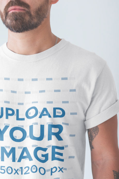 Closeup Tshirt Mockup of a Man with a Beard Wearing in a White Room