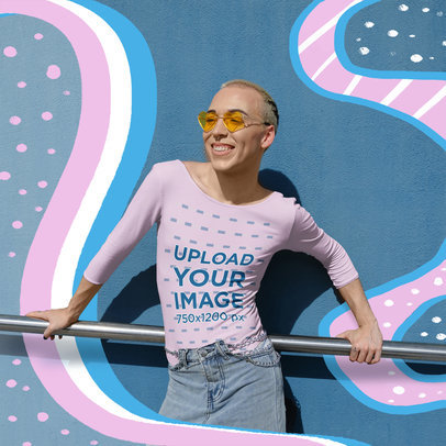 Mockup of a Smiling Non-Binary Person in a Long Sleeve T-Shirt Posing by a Railing  m33085 r-el2