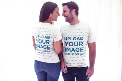 Mockup of a Couple Wearing T-Shirts Aganist White Curtains a20608
