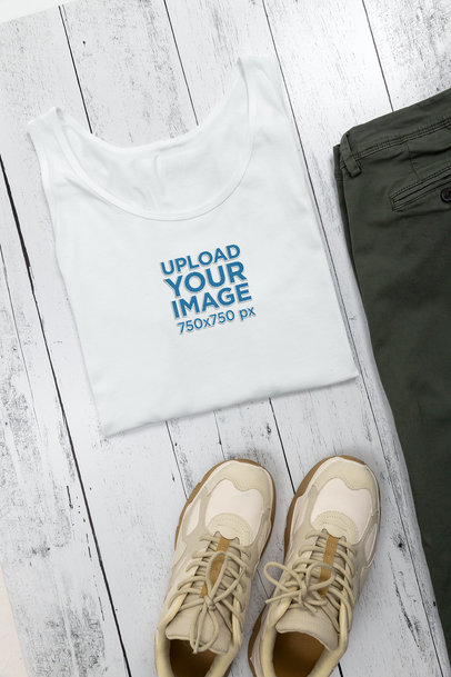 Mockup of a Bella Canvas Tank Top Folded over a Wooden Surface