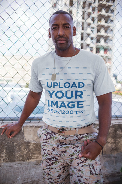 Veteran Wearing a T-Shirt Mockup while Standing Against a Fence