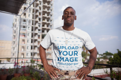 T-Shirt Mockup of a Veteran Standing on a Balcony